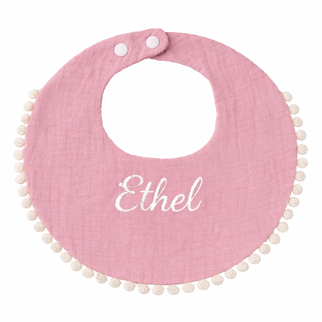 Bavoir bébé rond rose en gaze de coton avec bordure pompons et fermeture à pressions Broderie prénom 