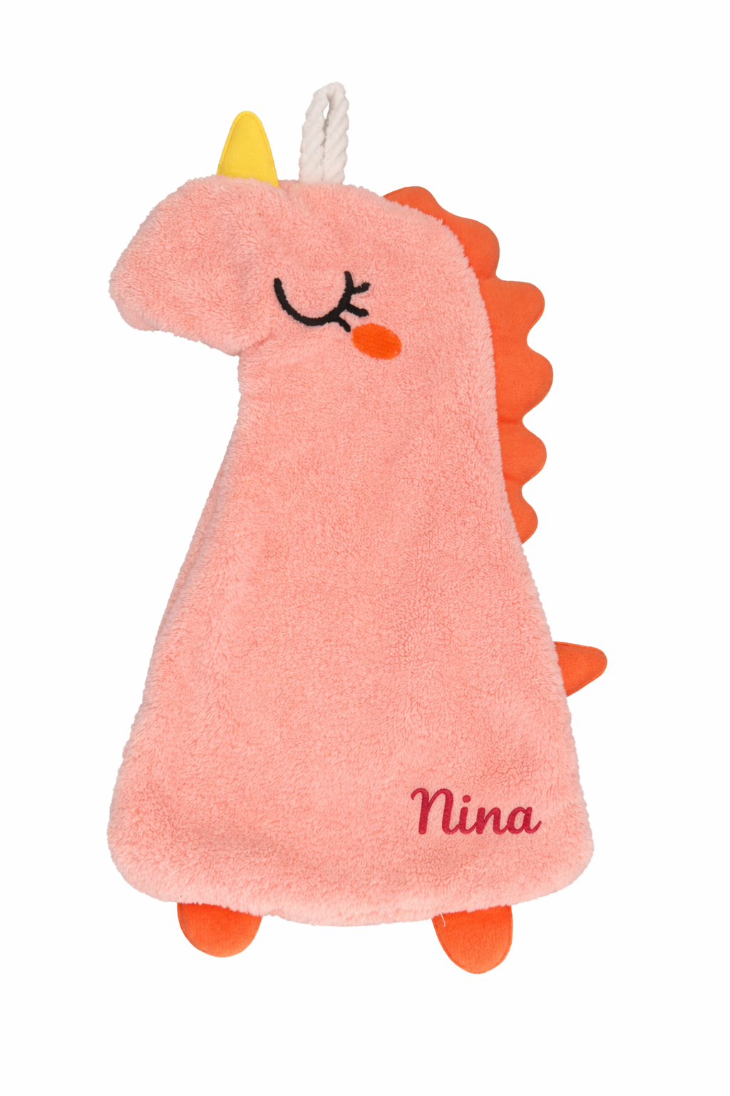 Doudou  en forme de dinosaure rose avec corne jaune et détails orange, personnalisée avec le prénom Nina brodé en rose foncé dans le coin inférieur droit sur fond blanc.